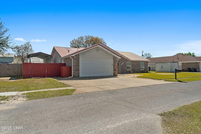 ranch-style house with a front yard, fence, driveway, stucco siding, and a garage