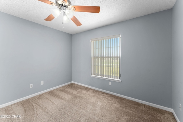 unfurnished room featuring baseboards, carpet, ceiling fan, and a textured ceiling