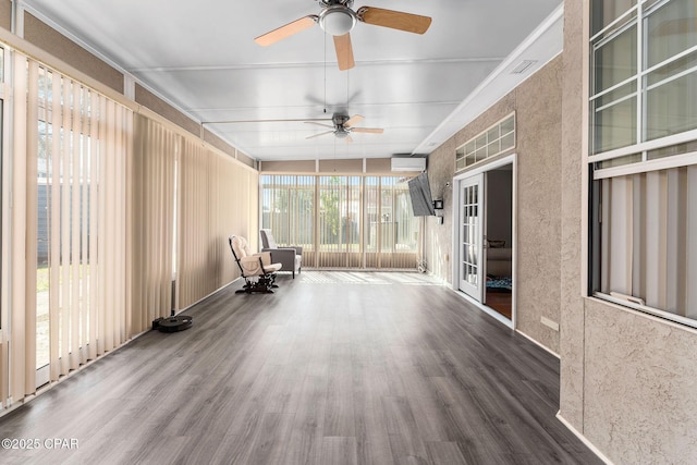 unfurnished sunroom featuring an AC wall unit, visible vents, and ceiling fan