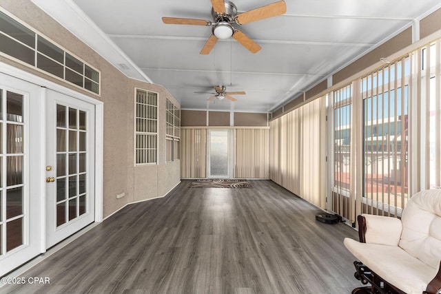 unfurnished sunroom with ceiling fan