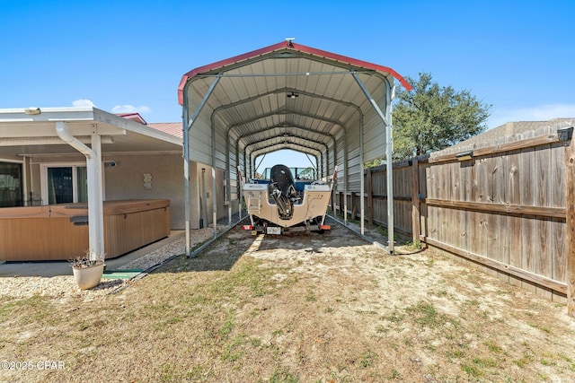 exterior space with a carport and fence