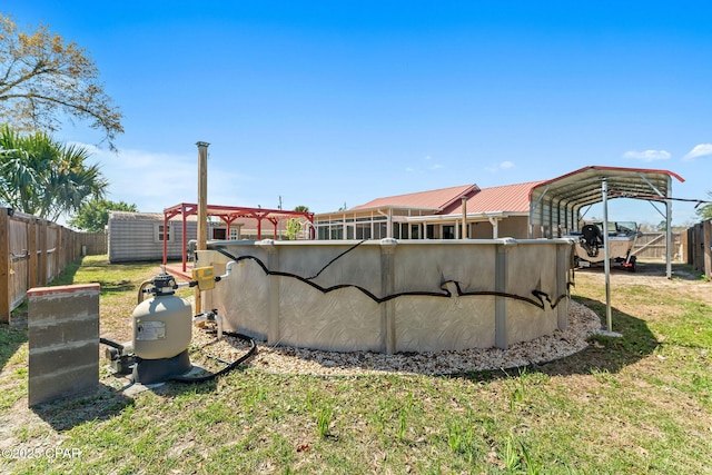 view of yard featuring a carport, a fenced backyard, a storage shed, and an outdoor structure