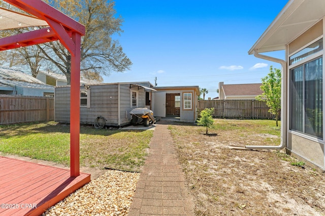 view of yard featuring an outdoor structure and a fenced backyard