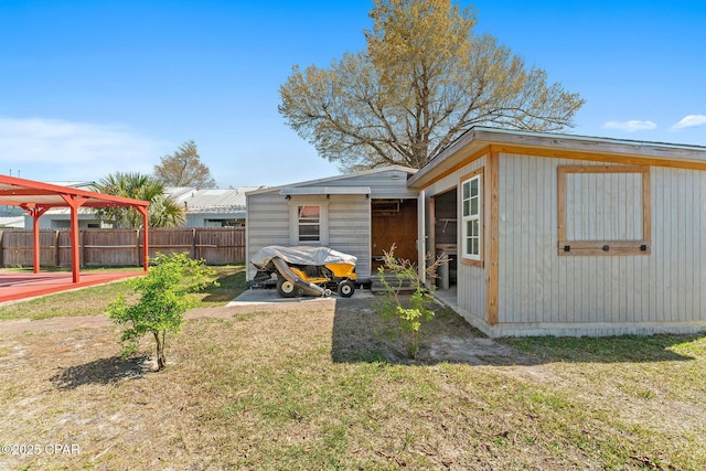 exterior space featuring a patio area, a yard, and fence