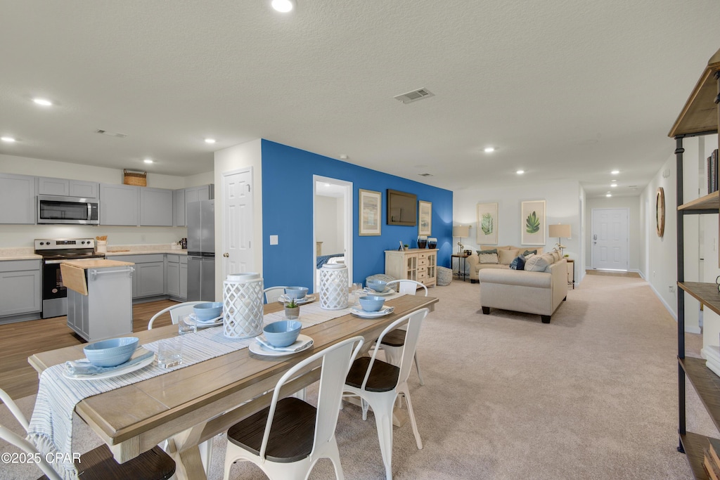 440 Salt Creek Ln Unit 28, Mexico Beach, FL 32456 - dining area with recessed lighting, baseboards, and light colored carpet