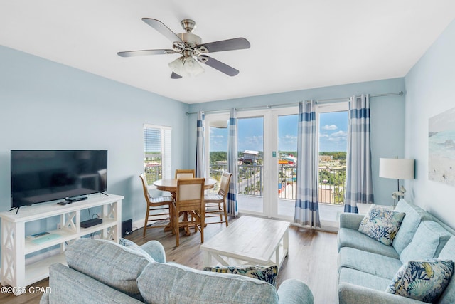 living room with ceiling fan and wood finished floors