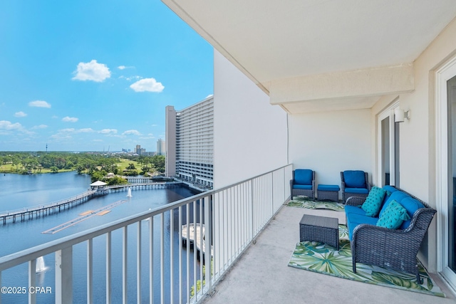 balcony with an outdoor hangout area and a water view