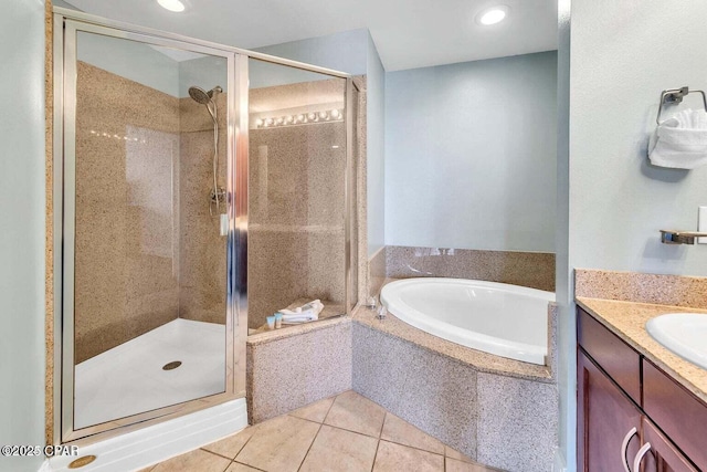 full bath with tile patterned flooring, a stall shower, vanity, and a garden tub