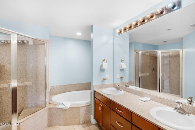 bathroom featuring double vanity, a sink, a shower stall, tile patterned floors, and a bath