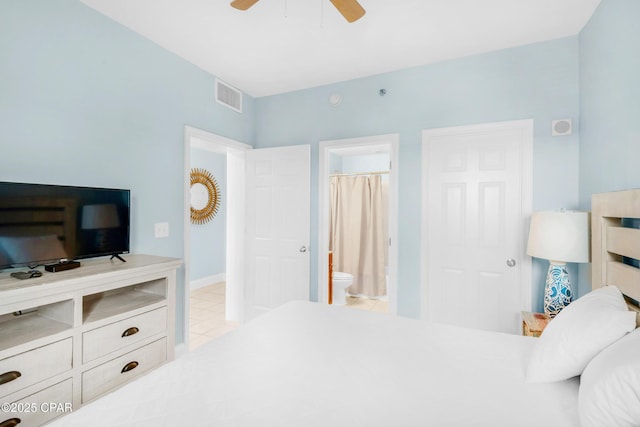 tiled bedroom featuring ceiling fan, baseboards, visible vents, and connected bathroom