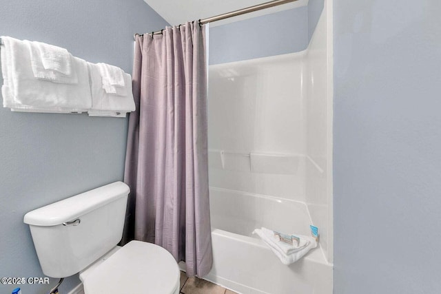 full bathroom featuring toilet and shower / bath combination with curtain