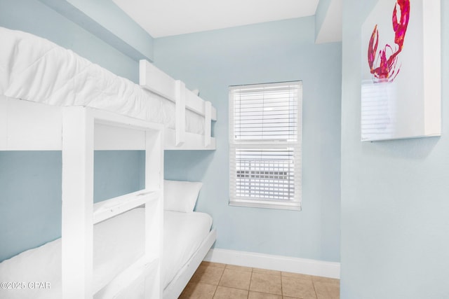 bedroom featuring tile patterned floors and baseboards