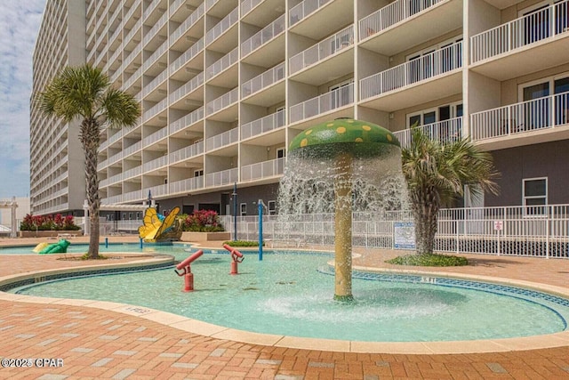 view of pool featuring a water slide and fence