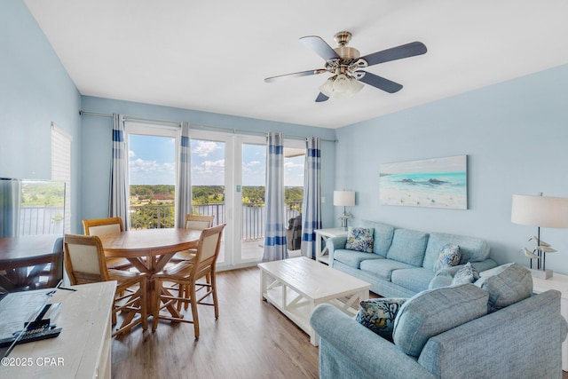 living room featuring light wood finished floors and a ceiling fan