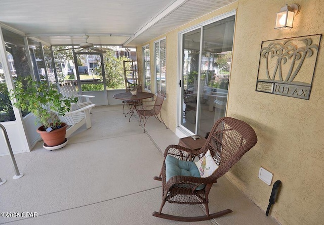 sunroom / solarium featuring ceiling fan