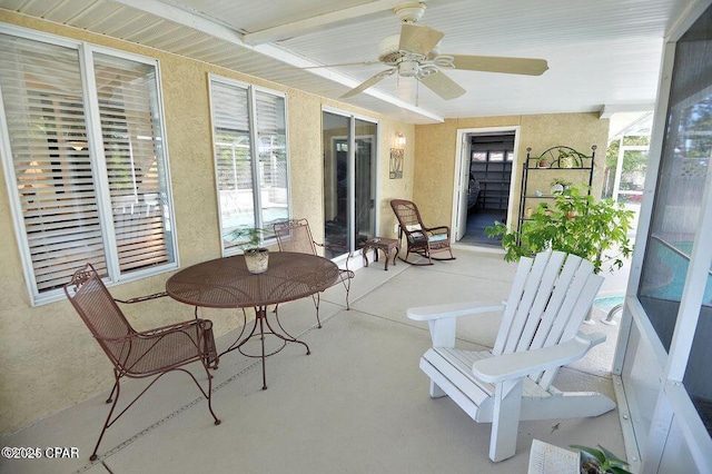 sunroom with ceiling fan