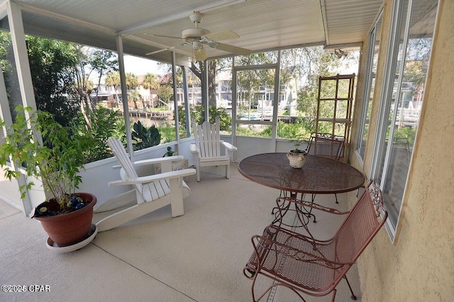 sunroom featuring plenty of natural light and a ceiling fan