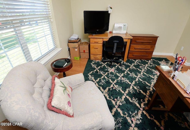 home office featuring baseboards and wood finished floors