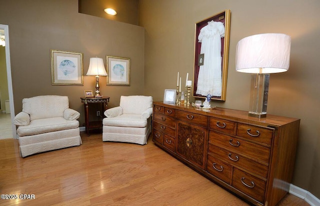 sitting room with light wood-type flooring and baseboards