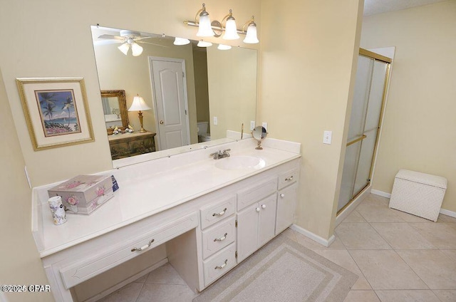 bathroom with tile patterned flooring, a shower stall, vanity, and ceiling fan