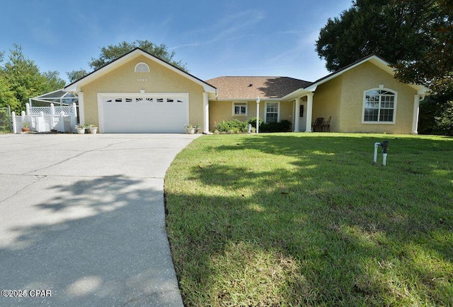 ranch-style house featuring a front yard, fence, driveway, stucco siding, and a garage