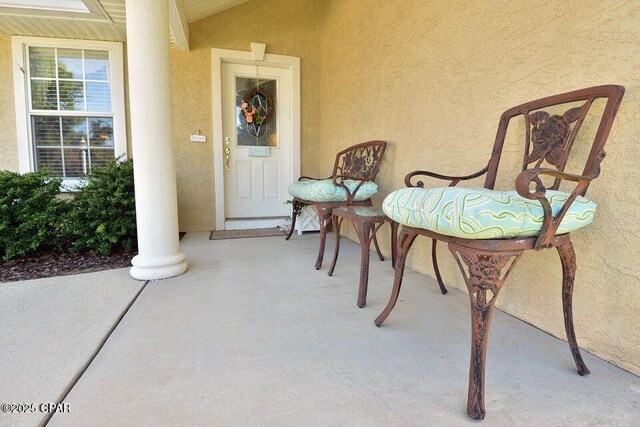 property entrance featuring stucco siding and a porch