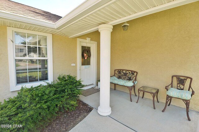 property entrance with stucco siding