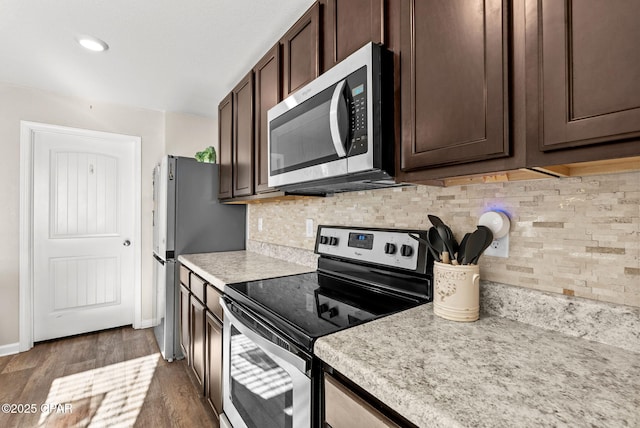 kitchen with dark brown cabinetry, appliances with stainless steel finishes, light countertops, and wood finished floors