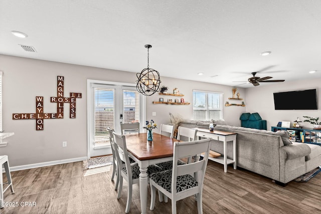 dining area featuring visible vents, baseboards, recessed lighting, ceiling fan with notable chandelier, and wood finished floors