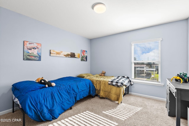 bedroom featuring baseboards and light colored carpet