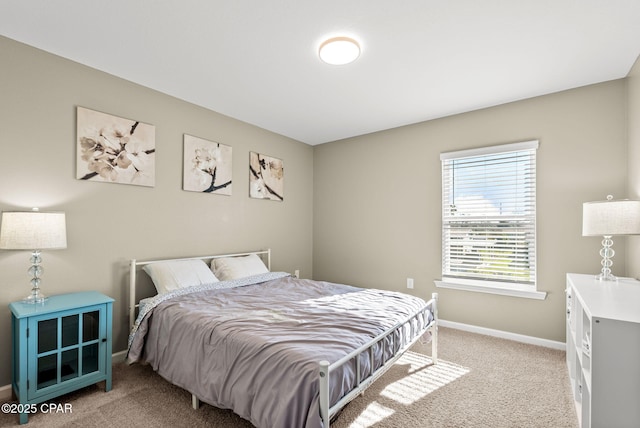 bedroom with light carpet and baseboards