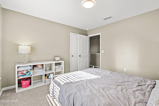 bedroom with visible vents, carpet floors, baseboards, and a closet