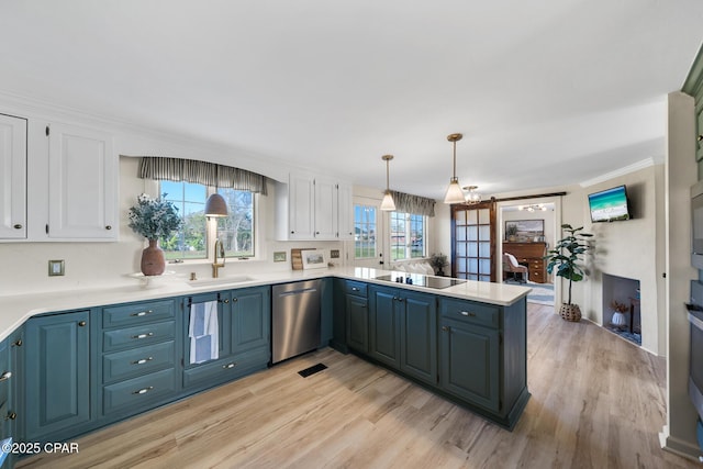 kitchen featuring a sink, a peninsula, white cabinetry, black electric cooktop, and stainless steel dishwasher