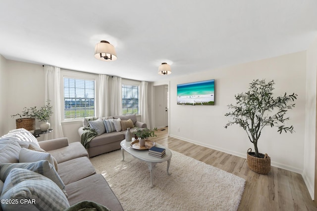 living room featuring baseboards and light wood-style floors