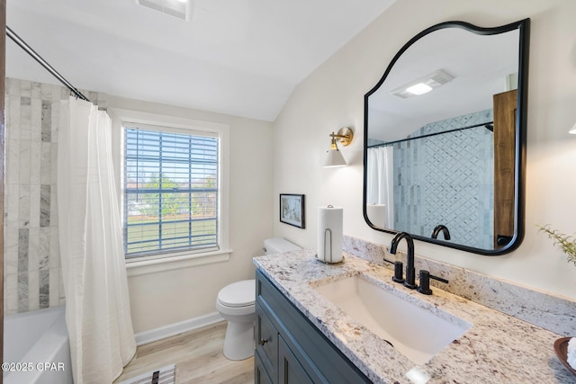 full bathroom with visible vents, toilet, vaulted ceiling, wood finished floors, and vanity