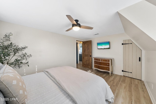 bedroom featuring visible vents, light wood-style flooring, baseboards, and a ceiling fan