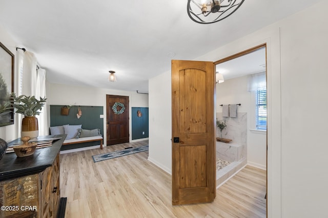 entrance foyer featuring light wood finished floors and baseboards