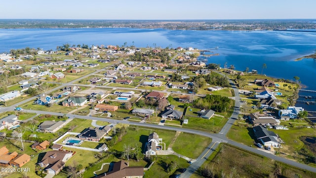 birds eye view of property with a water view and a residential view