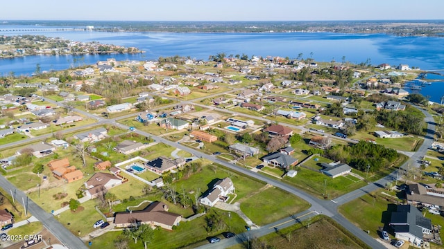 birds eye view of property with a water view and a residential view