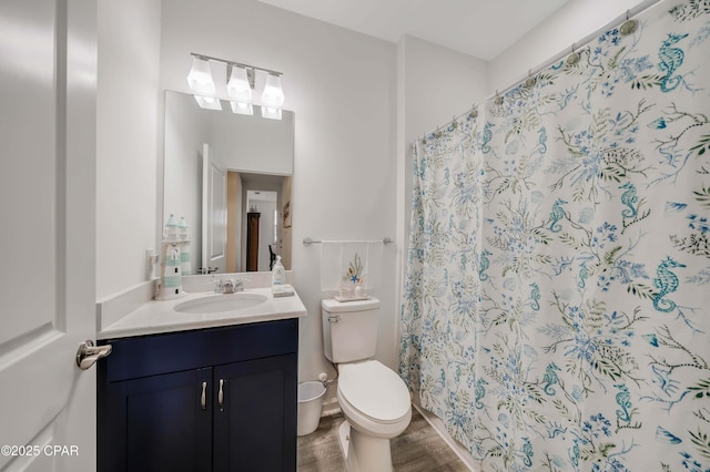 full bath featuring curtained shower, toilet, wood finished floors, and vanity