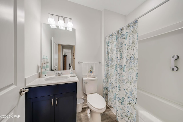 bathroom with shower / bath combo with shower curtain, toilet, wood finished floors, and vanity