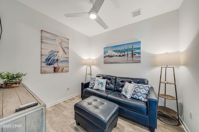 living room with visible vents, baseboards, ceiling fan, and wood finished floors