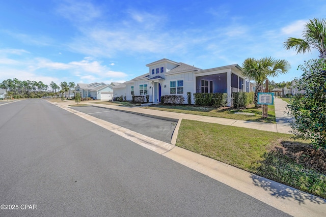 view of front facade with a residential view and a front yard