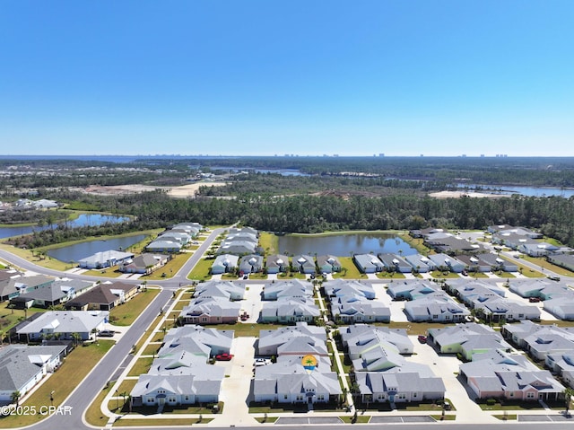 drone / aerial view with a residential view and a water view