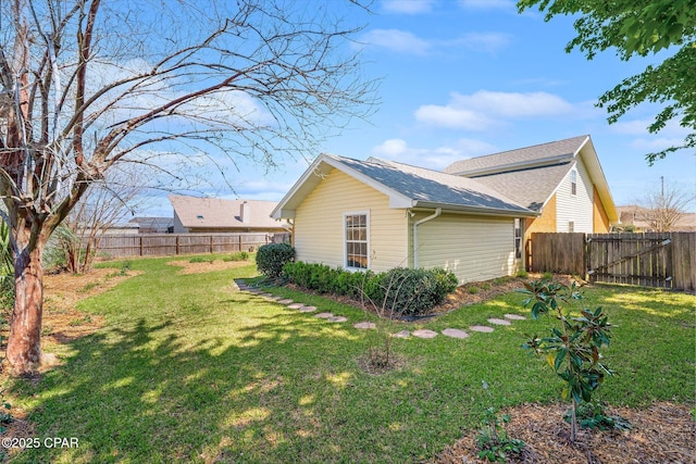 view of home's exterior featuring a yard and a fenced backyard