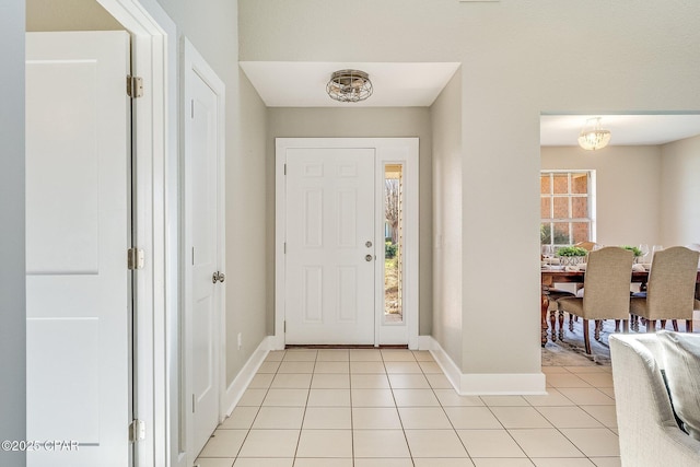 foyer featuring light tile patterned floors and baseboards