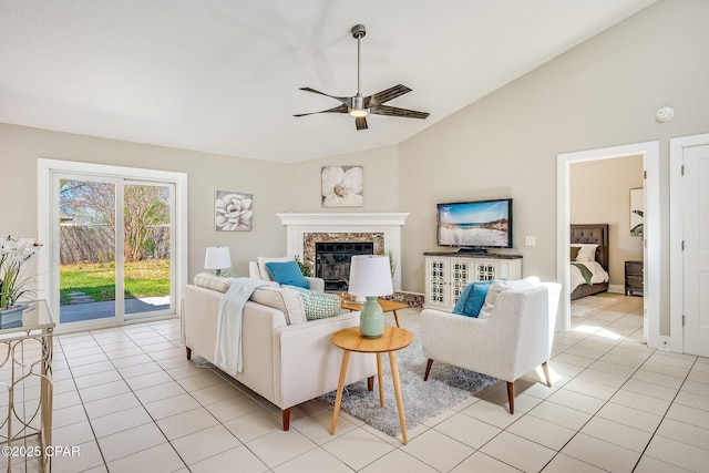 living room with lofted ceiling, a fireplace, light tile patterned flooring, and a ceiling fan