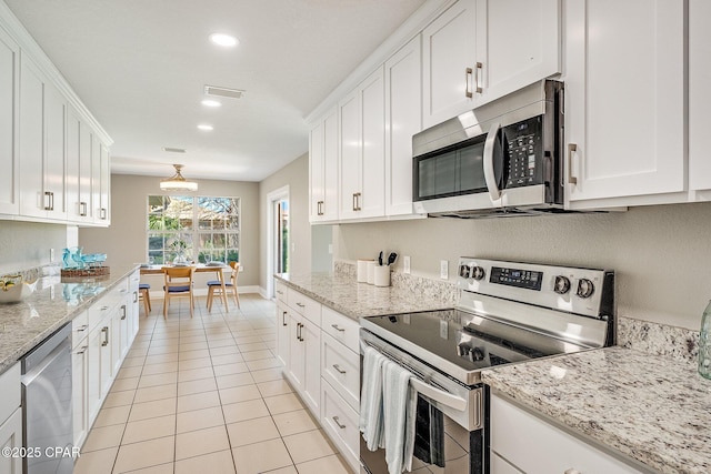 kitchen featuring white cabinetry, light tile patterned flooring, recessed lighting, and stainless steel appliances