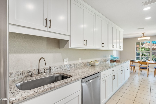 kitchen featuring light tile patterned floors, visible vents, white cabinetry, a sink, and stainless steel dishwasher