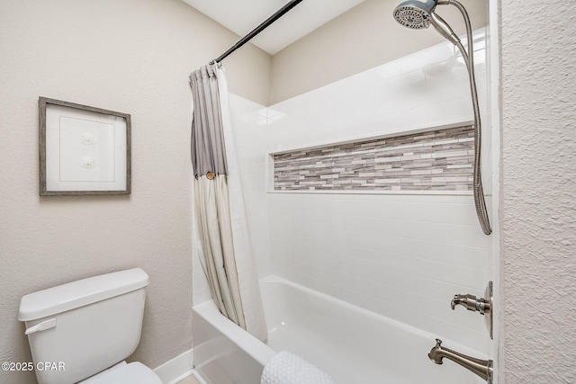 full bath featuring shower / bath combination with curtain, toilet, and a textured wall